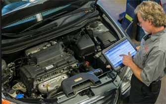 A mechanic browses the results of a test